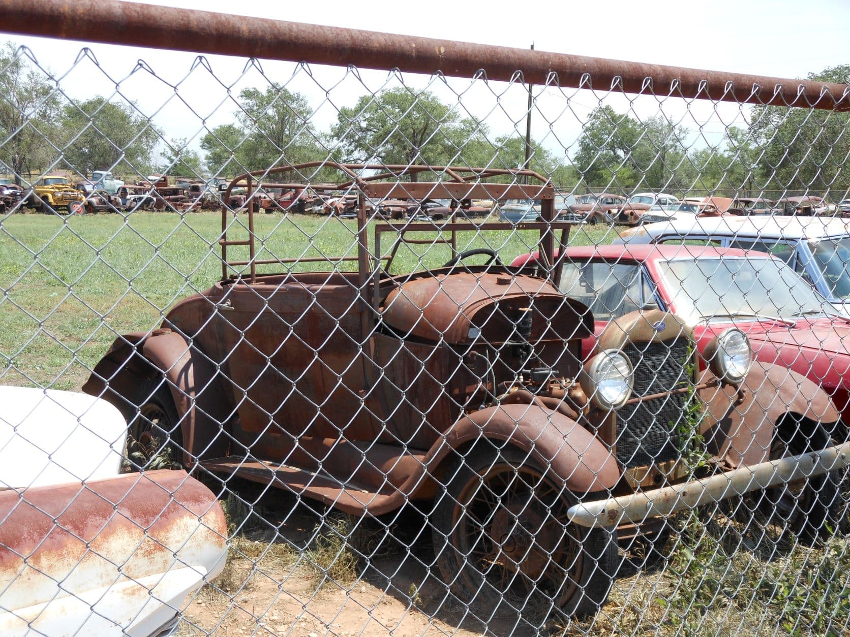 Shamrock, TX - Lost 1930s Ford with roll cage? The headlights look good.